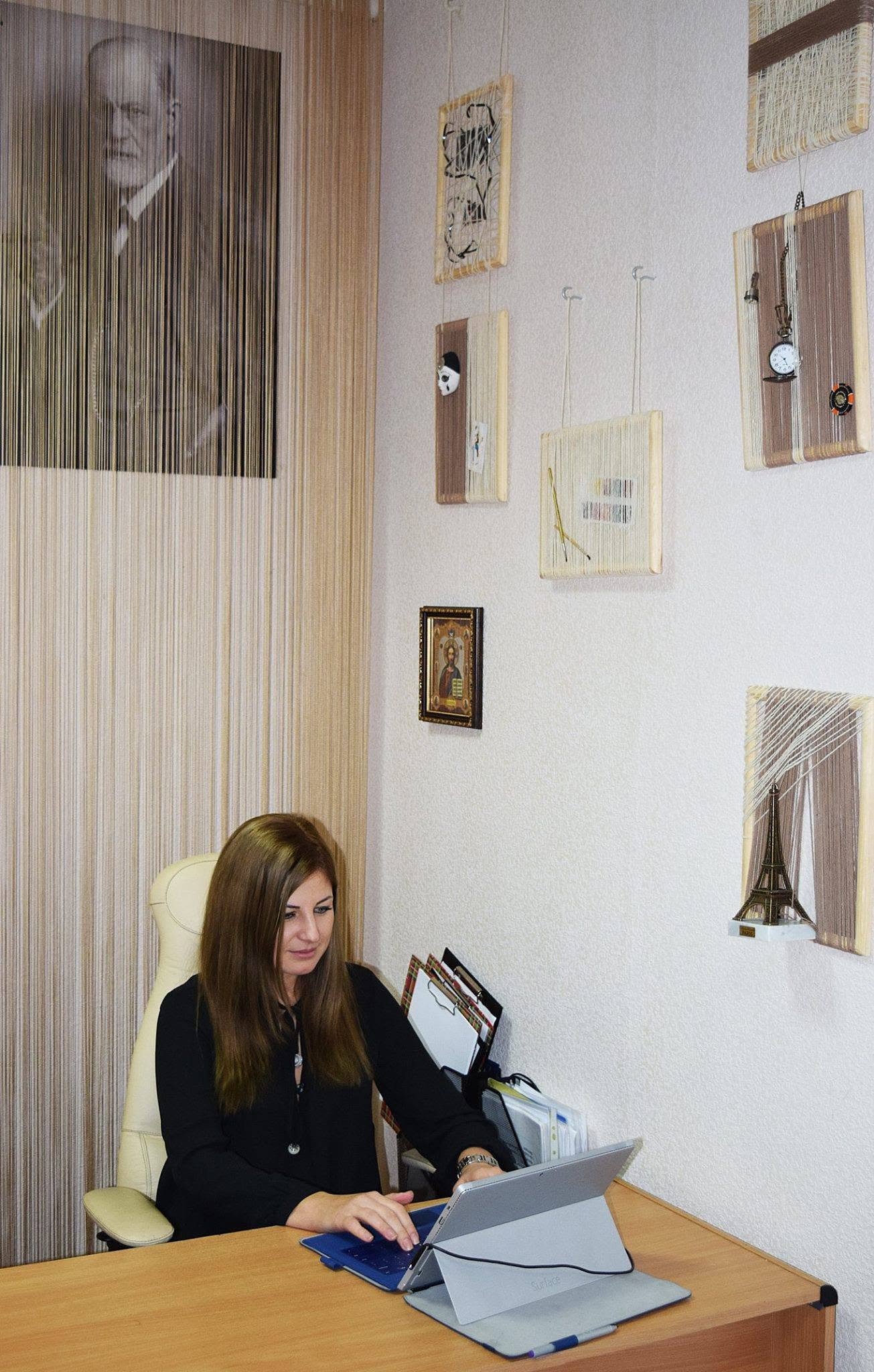 Viktoriia working in the office where she began building her private practice